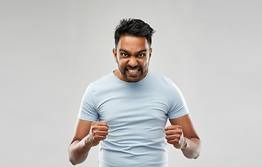 Image showing angry indian man screaming over grey background