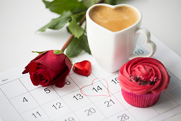 Image showing close up of calendar, coffee, cupcake and red rose