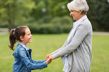 Image showing grandmother and granddaughter playing at park