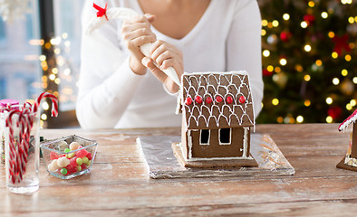 Image showing woman making gingerbread houses on christmas