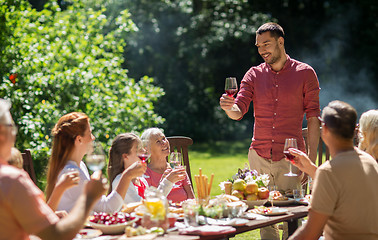 Image showing happy family having dinner or summer garden party