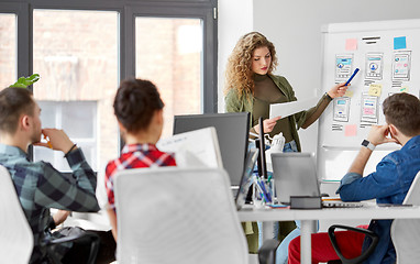 Image showing creative woman showing user interface at office