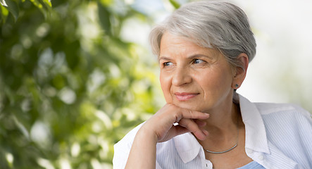 Image showing portrait of senior woman over natural background