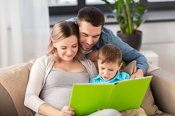 Image showing happy family reading book at home