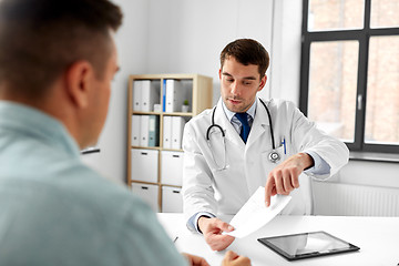 Image showing doctor giving prescription to patient at hospital