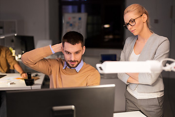 Image showing business team with computer working late at office