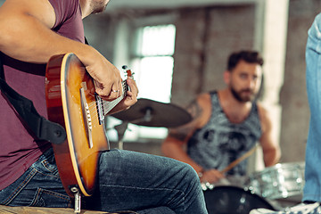 Image showing Repetition of rock music band. Electric guitar player and drummer behind the drum set.