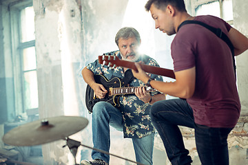 Image showing Repetition of rock music band. Electric guitar players