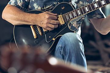 Image showing Repetition of rock music band. Electric guitar player and drummer behind the drum set.