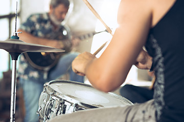 Image showing Repetition of rock music band. Electric guitar player and drummer behind the drum set.