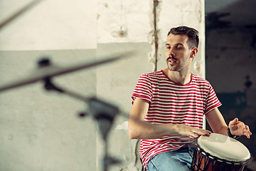 Image showing Repetition of rock music band. drummer behind the drum set.