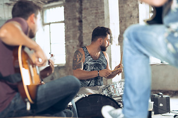 Image showing Repetition of rock music band. Electric guitar player and drummer behind the drum set.