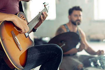 Image showing Repetition of rock music band. Electric guitar player and drummer behind the drum set.