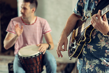 Image showing Repetition of rock music band. Electric guitar player and drummer