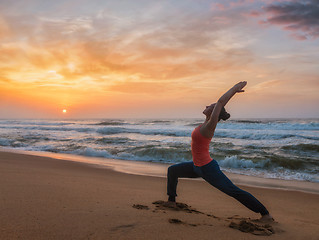 Image showing Woman doing yoga asana Virabhadrasana 1 Warrior Pose on beach on