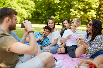 Image showing friends with drinks photographing at summer picnic