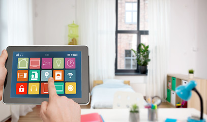 Image showing hands with smart home icons on tablet computer
