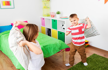 Image showing children playing and fighting by pillows at home