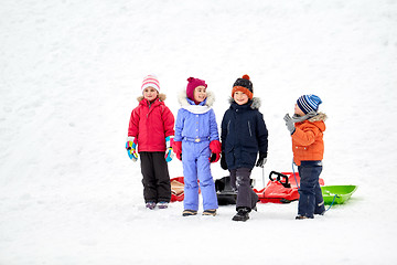 Image showing happy little kids with sleds in winter