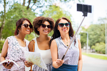 Image showing women with city guide and map taking selfie