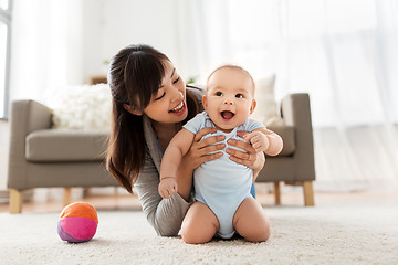 Image showing happy young mother with little baby at home