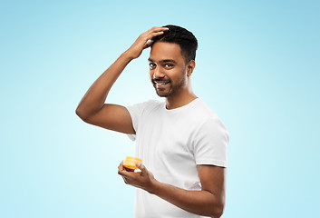 Image showing indian man applying hair wax or styling gel