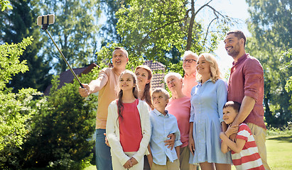 Image showing happy family taking selfie in summer garden