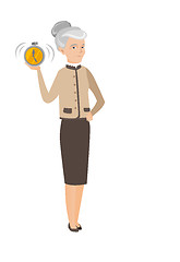 Image showing Caucasian business woman holding alarm clock.