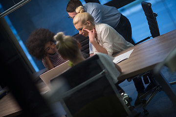 Image showing Multiethnic startup business team in night office