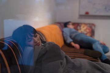 Image showing software developers sleeping on sofa in creative startup office