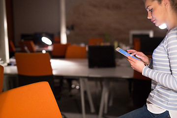 Image showing woman working on digital tablet in night office