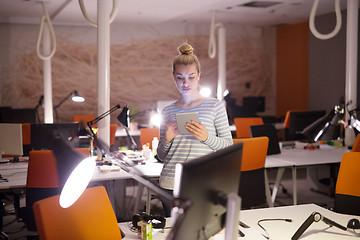 Image showing woman working on digital tablet in night office