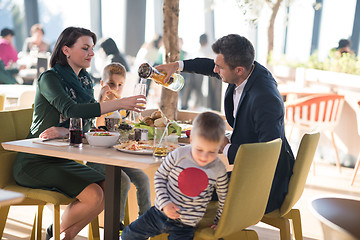 Image showing Young parents enjoying lunch time with their children