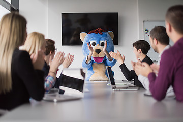 Image showing boss dresed as bear having fun with business people in trendy of