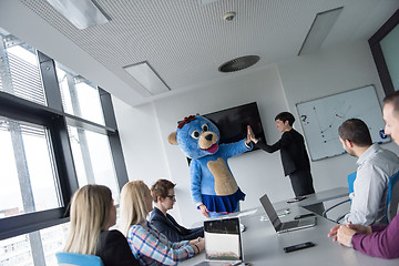 Image showing boss dresed as bear having fun with business people in trendy of