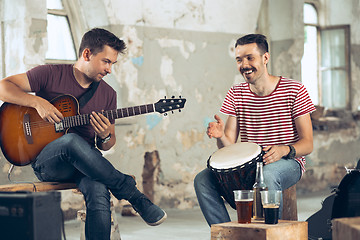 Image showing Repetition of rock music band. Electric guitar player and drummer behind the drum set.