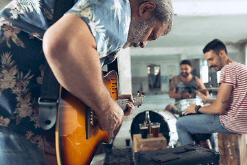 Image showing Repetition of rock music band. Electric guitar player and drummer behind the drum set.