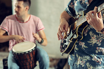 Image showing Repetition of rock music band. Electric guitar player and drummer