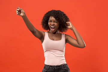 Image showing Winning success woman happy ecstatic celebrating being a winner. Dynamic energetic image of female afro model