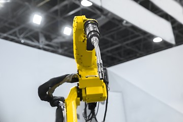 Image showing Automatic robot arm working in industrial environment