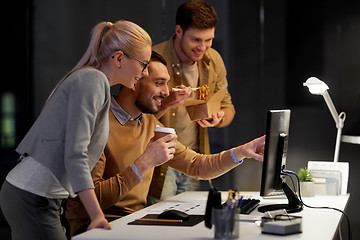 Image showing business team with computer working late at office