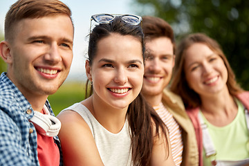 Image showing happy teenage friends outdoors in summer