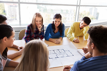 Image showing group of smiling students with blueprint