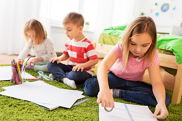 Image showing children drawing and making crafts at home