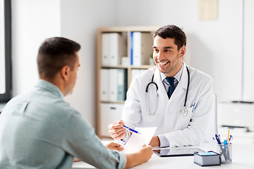 Image showing doctor showing prescription to patient at hospital