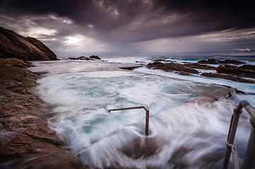 Image showing Turbulent ocean, big swell and surging rock pool overflows