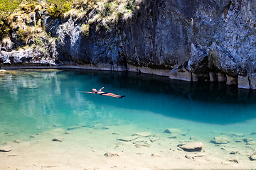 Image showing Female floating in natural blue pools