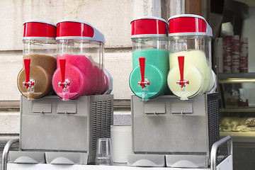 Image showing Four flavors of grenadine ice for sale on the street