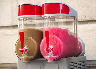 Image showing Two flavors of grenadine ice for sale on the street