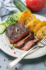 Image showing Entrecote with fried potatoes and cucumber.